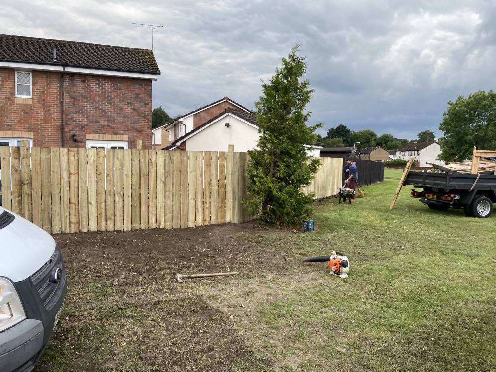 Close-board timber fence installation in residential garden