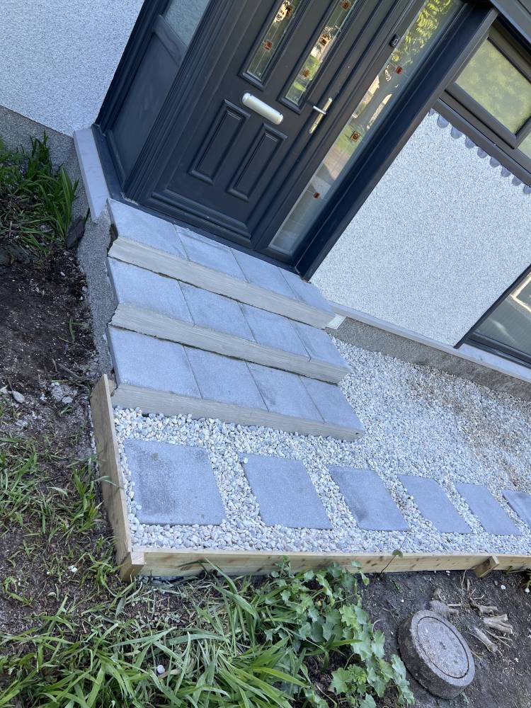 Granite doorstep with gravel surround at front entrance