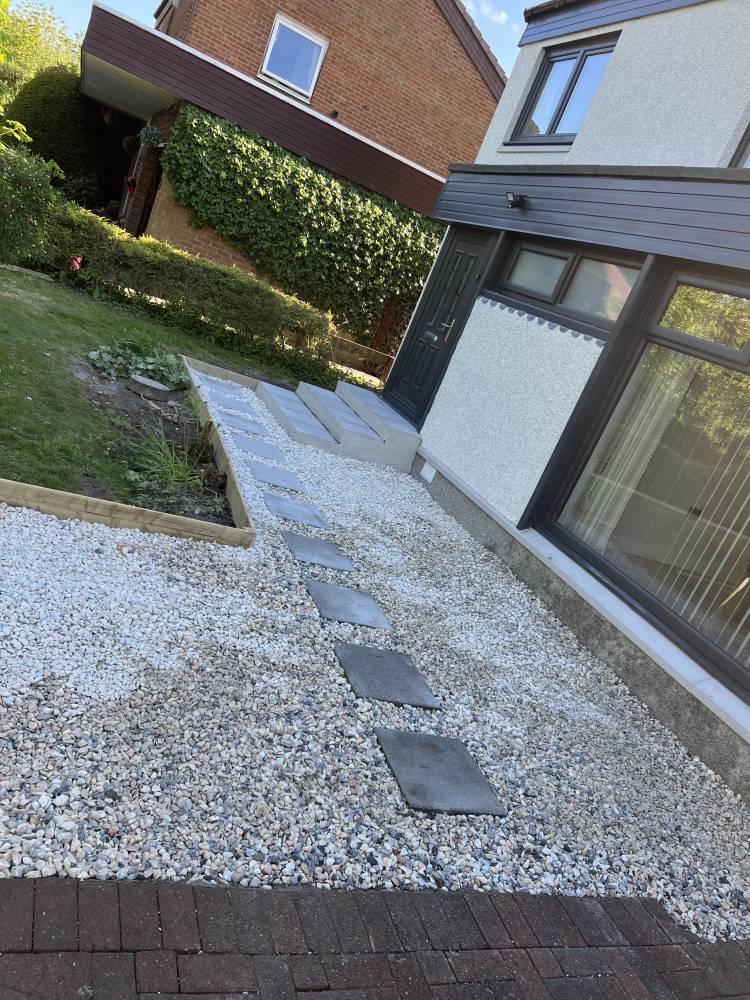 Gravel path with stepping stones alongside house
