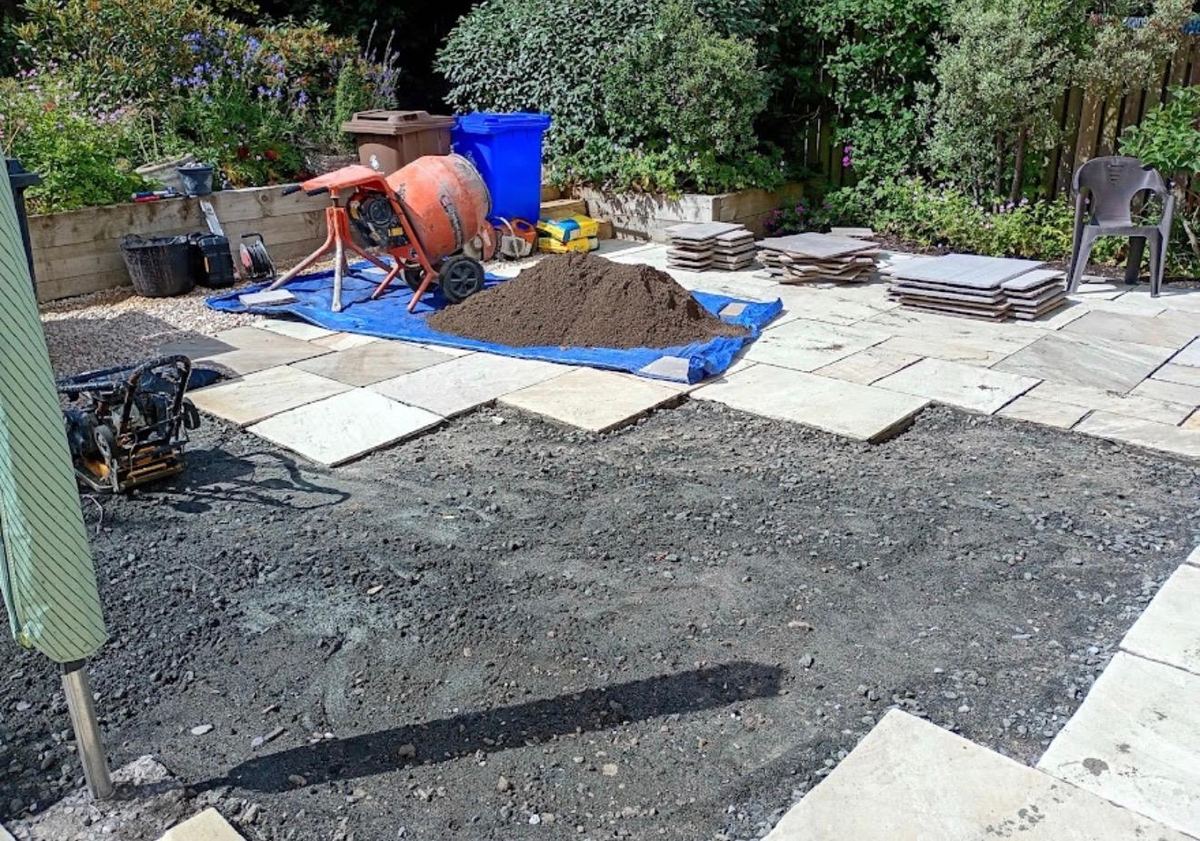 Indian sandstone patio being laid with mixer and slabs on site