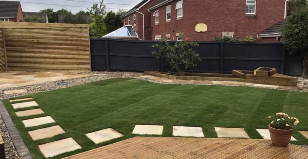 Landscaped garden with turf, sandstone stepping stones and timber sleepers