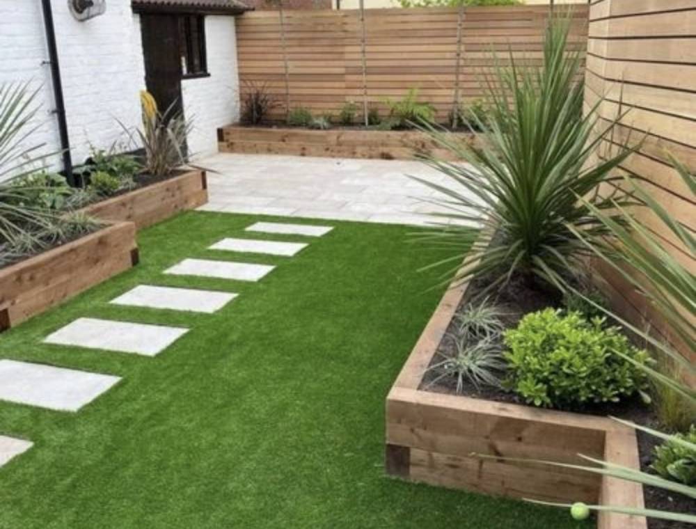 Modern garden with slatted fence and raised beds