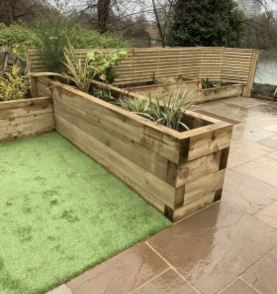 Raised sleeper planter with slatted fence and patio by Forth Tree Garden Landscaping