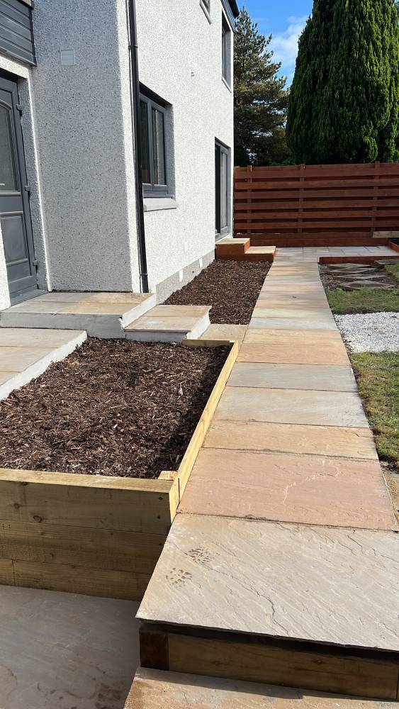 Indian sandstone garden path with timber raised beds in Clackmannanshire