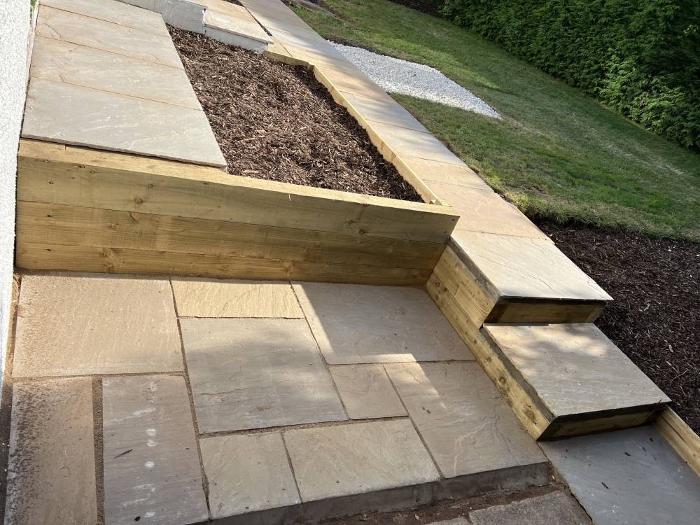 Sandstone patio steps with timber raised planter detail