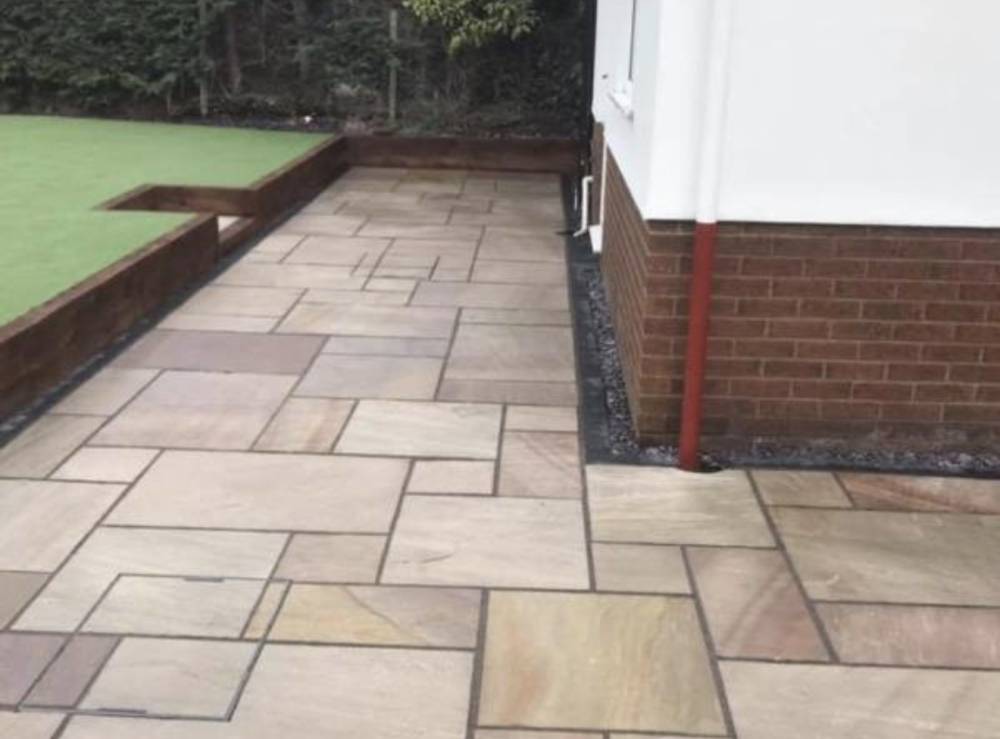 Sleeper retaining wall with steps in residential garden