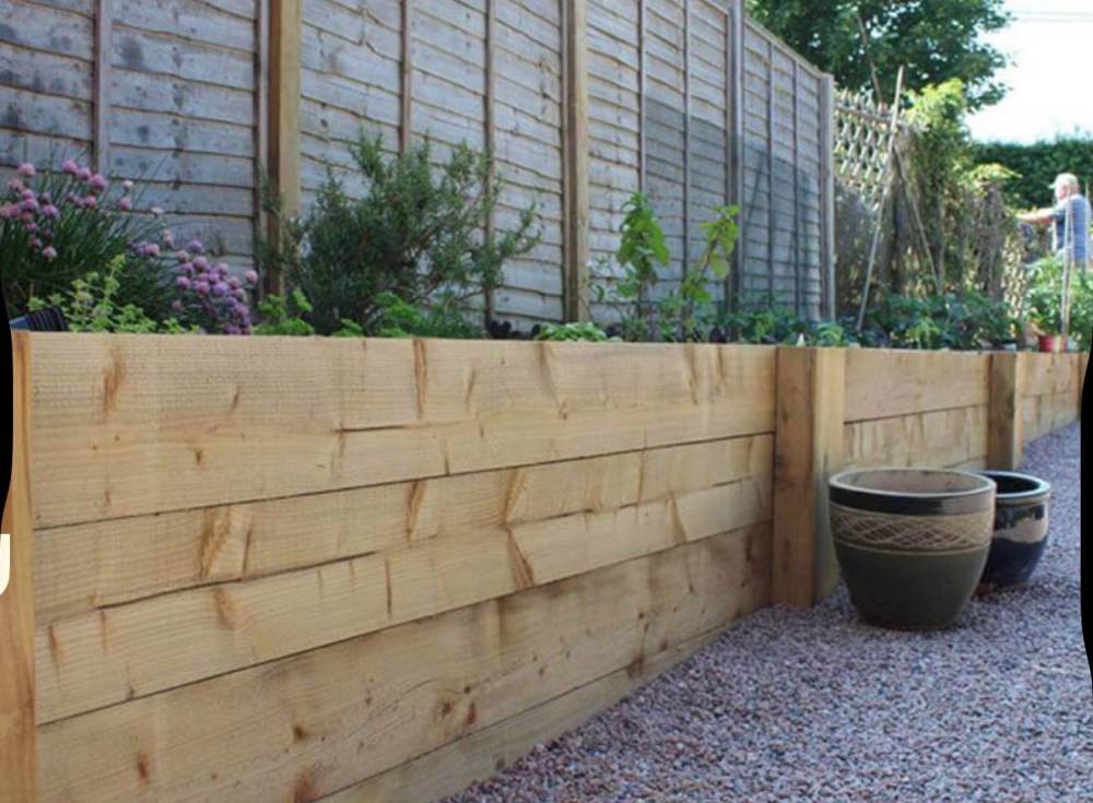 Timber sleeper planter bed with gravel path and garden pots