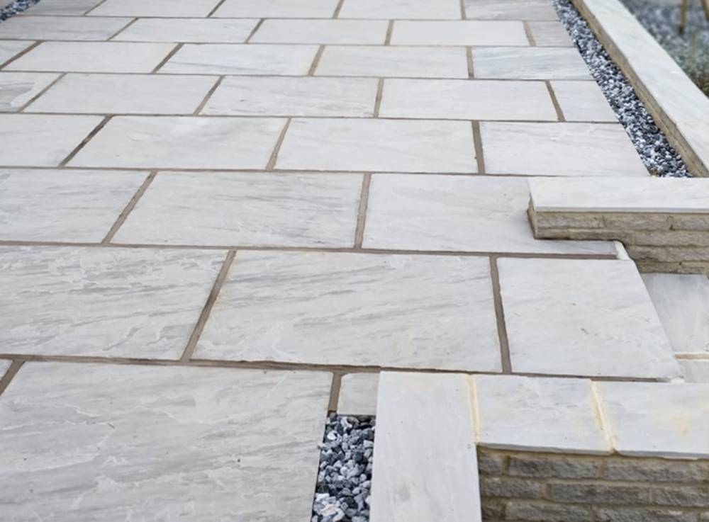 Timber sleeper steps with sandstone patio landing area